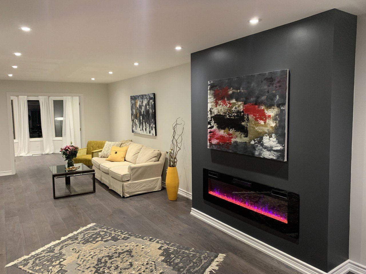 Living room after renovation with feature fireplace wall