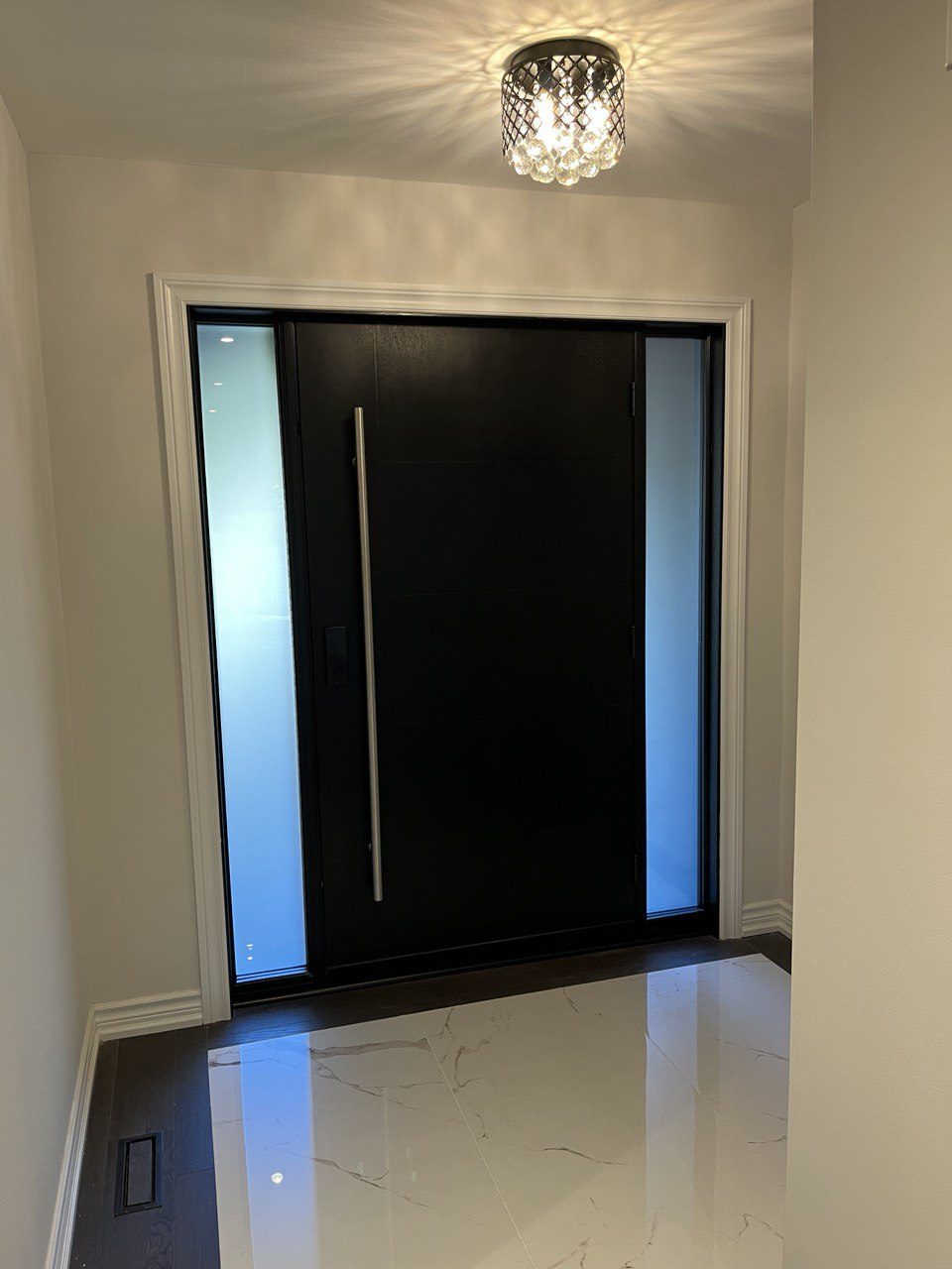 Front entry before renovation, dated white paneled door